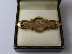 A Lady's 9 ct Gold Edwardian Brooch, with horse shoes amongst a floral spray design, 2.2 gms.