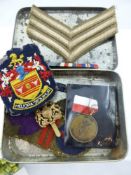 A Box of Miscellaneous Military Badges, including cloth and metal.