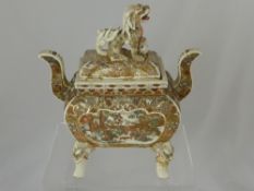 A satsuma ceramic censer supported on four legs, each having a dragon's head, the censer being