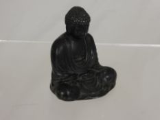 A Metal Figure of a Seated Buddha with character marks to base approx. 8.5 cms.