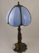 A Tiffany Style Table Lamp, the shade being of blue sections, on an ornate metal column, fluted