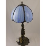 A Tiffany Style Table Lamp, the shade being of blue sections, on an ornate metal column, fluted