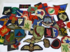 A Large Miscellaneous Collection of Military and other shoulder cloth badges, including tank