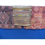 Two Middle Eastern Floor Cushion Covers and a Camel Saddle Bag.