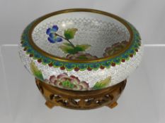 A Chinese Cloisonne Bowl depicting tree peony and butterfly supported on a decorative fruit wood