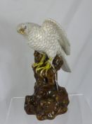 A Continental Figure of a Bird of Prey seated, approx 32 cms.