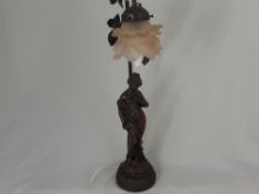 A vintage art deco style metal table lamp in the form of a lady, the lamp support having leaf