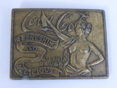 A Vintage American Metal Coca Cola Belt Buckle. The buckle depicting a naked lady with arm