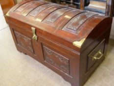 A Middle Eastern Rosewood Effect Dome Top Chest. The chest having covered panels and tray within.