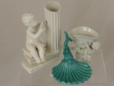 Two white Italian ceramic figures - one being in the form of a cherub sitting beside a fluted