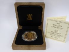 A Royal Mint 1989 United Kingdom £5 Brilliant Uncirculated Gold Coin. With original box and