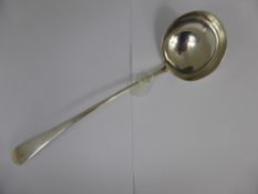 A solid silver Georgian punch ladle.