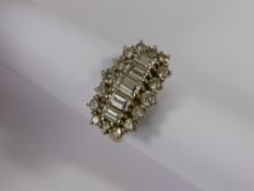 A Lady's 18 ct Yellow and White Gold Diamond Cluster Ring. The top shoulder set with 5 graduated