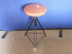 A 1960's Adjustable Stool having a black metal framed base.