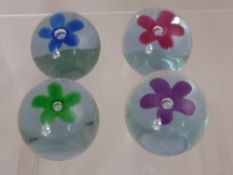 Four Caithness Pop Flower Paperweights, including Purple, Blue, Green and Pink.
