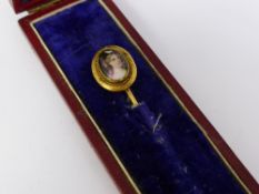 A Gentleman's Antique Gold Hand Painted Porcelain Tie Pin. The tie pin depicting a young lady.