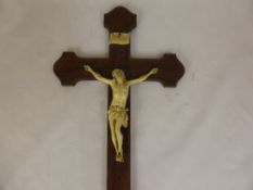 An Antique Ivorine Crucifix, set on a brass edged Rosewood frame, approx 41 x 22 cms