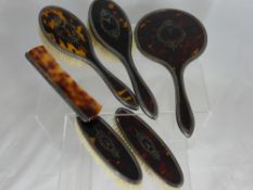 A Lady's Edwardian Silver and Tortoise Shell Dressing Table Set, comprising mirror, two hairbrushes,