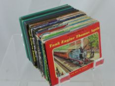 Twelve Vintage Thomas the Tank Engine Books, some with the original covers.