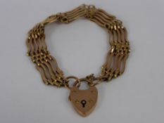 A 9 ct Rose Gold Hallmark Gate Link Bracelet. The bracelet having a heart form clasp, approx 19.5