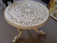 An Ornate White Painted Metal Garden Table, approx. diameter 62 cms, height 45 cms.