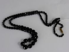 A Victorian Faceted Witby Jet Mourning Necklace. The necklace of graduated beads approx 81 cms long.