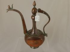 A vintage Turkish style copper coffee pot having a figure of a bird to the top of the spout and