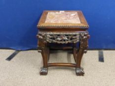 An Antique Chinese Rose Wood Plant Stand having a floral frieze on ball and claw feet, approx. 35