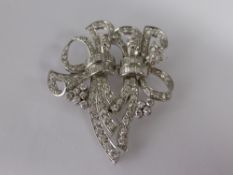 An 18 carat White Gold and Diamond Brooch, the double ribbon form brooch set with approx 5.28 cts of