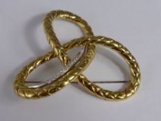 An 18 carat, (750 hmk) White and Yellow Gold Diamond Brooch, the knot form brooch set with