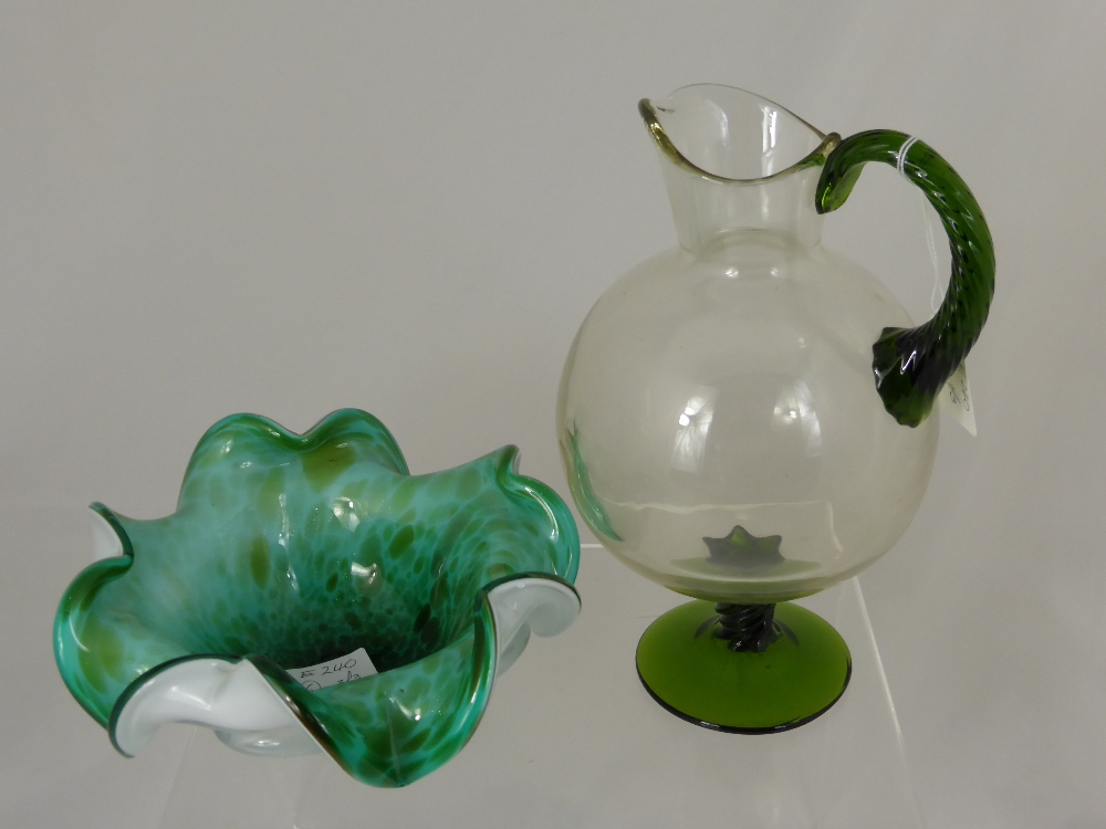 Three pieces of glass comprising a vintage water jug having a green base and twisted stem, the top