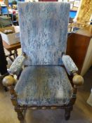 An Oak High Back Armchair with turned stretchers, the seat, back and arms being covered in a