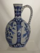 A Blue and White Delft Pottery Jug depicting birds in a garden, 31 cms high.