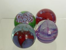 Four Caithness Glass Paper Weights, including 'Crucible', 'Only a Rose', 'Diabolo', and 'Oriental