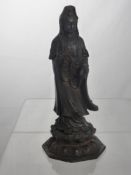 An Antique Metal Tibetan Deity, depicted standing on a lotus base in flowing robes, approx 28 cms