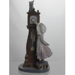 A Lladro Figure of a Girl at a Grandfather clock, impressed marks to base 5437 C-25 S, 28 cms high.