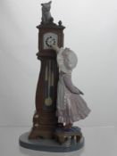 A Lladro Figure of a Girl at a Grandfather clock, impressed marks to base 5437 C-25 S, 28 cms high.