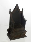 A Harper Cast Iron Money Box in the form of a throne dated 1953.