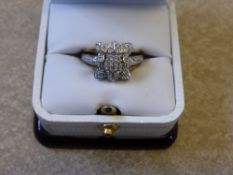 A Lady's 9 ct Gold and Diamond Ring, the pave set ring set with diamonds in the form of a flower,