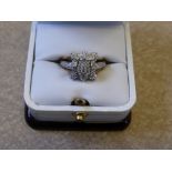 A Lady's 9 ct Gold and Diamond Ring, the pave set ring set with diamonds in the form of a flower,