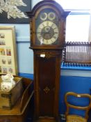 An antique oak long case clock, the face being brass and silver metal with Roman numerals, the clock