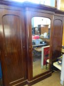 A Victorian Mahogany Wardrobe Compactum, the wardrobe having cupboards either side of a mirrored