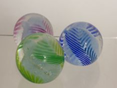 Three Glass Caithness Paper Weights, including 'Chevron' in green, blue and red.