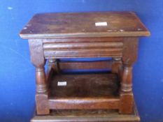 An Oak Footstool on Turned Legs.