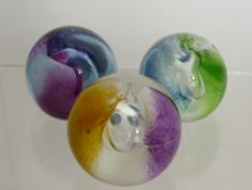 Three Caithness Glass Paper Weights, including 'Neon' in green, Blue and Amber.