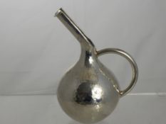 A Grecian Hammered Silver Pouring Vessel. Stamped 925 and E7 to base, approx 19 cms h, approx 208