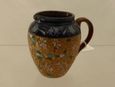 A Royal Doulton Milk Jug, of decorative floral design with white and turquoise highlights.