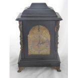 An Antique German Ebonised Bracket Clock, the clock features a brass face with Roman dial and