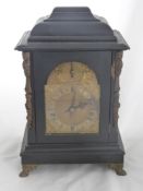 An Antique German Ebonised Bracket Clock, the clock features a brass face with Roman dial and