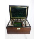 A Rosewood Ladies Vanity Box with fitted interior comprising three glass jars, five cut glass